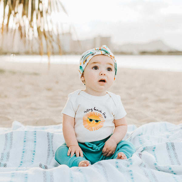 Finn + Emma Resting Beach Face onesie
