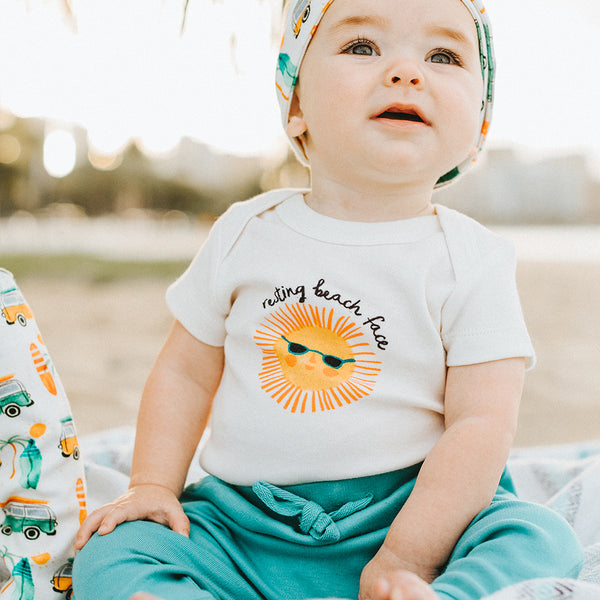 Finn + Emma Resting Beach Face onesie