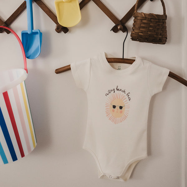 Finn + Emma Resting Beach Face onesie